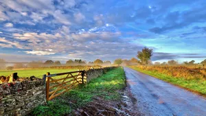 French Countryside Road Under Cloudy Sky Wallpaper