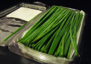 Fresh Garlic Chives On Plastic Packaging Wallpaper