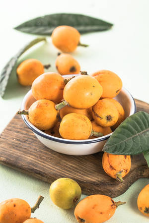 Fresh Loquat Fruits On A Chopping Board Wallpaper