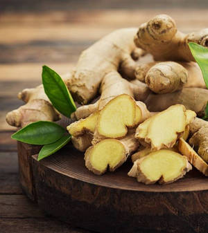 Freshly Sliced Ginger Rhizomes On Chopping Board Wallpaper