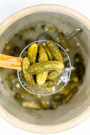 Freshly Washed Pickles In A Strainer Wallpaper