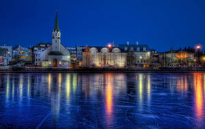 Frozen Lake Near City Wallpaper
