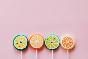 Fruit Lollipops On A Hot Pink Background Wallpaper