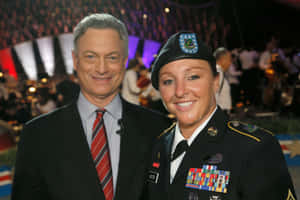 Gary Sinise With Military Personnel Wallpaper