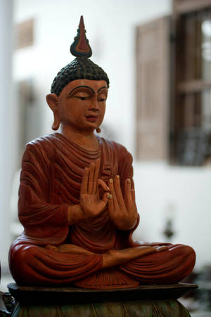 Gautam Buddha Sculpted Wooden Statue Wallpaper