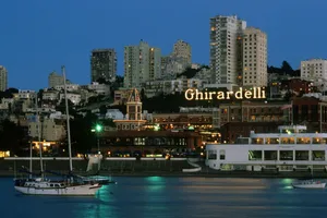 Ghiradelli Square By Ocean With Boats Wallpaper