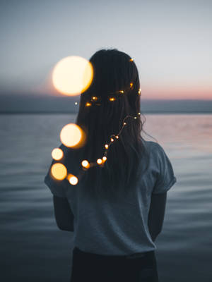 Girl Aesthetic In Beach With Fairy Lights Wallpaper