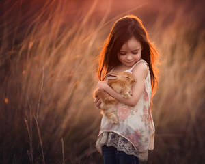 Girl Child Holding A Rabbit Wallpaper