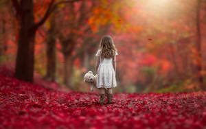 Girl Child On Red Autumn Leaves Wallpaper