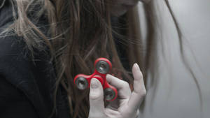 Girl Playing Fidget Toy Wallpaper