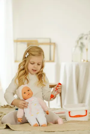 Girl Playing With Cute Doll Wallpaper