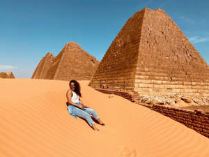 Girl Sitting In Sudan Desert Wallpaper