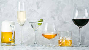 Glasses Of Alcohol On White Marble Wallpaper