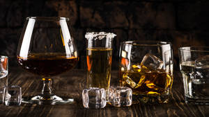 Glasses Of Alcohol With Ice Wallpaper