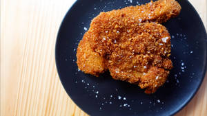 Glazed Tonkatsu On A Black Round Plate Wallpaper