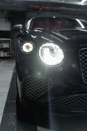Gleaming Black Luxury Car Front View Wallpaper