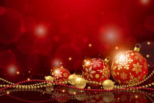 Gleaming Red Christmas Balls Hanging At Event Wallpaper