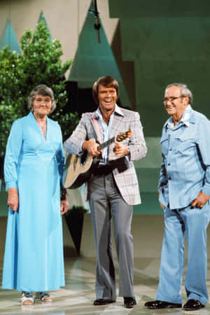 Glen Campbell With Guitar On Stage Wallpaper