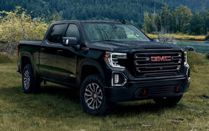 Gmc On A Grassy Ground Wallpaper