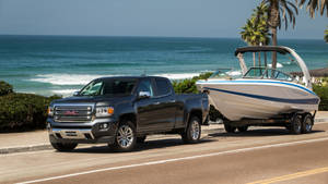Gmc Vehicle And A Motor Boat Wallpaper