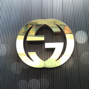 Gold Gucci Logo Signage Wallpaper