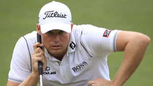 Golfer Concentration During Putt Wallpaper