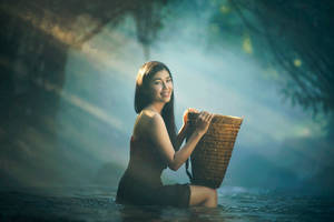 Graceful Asian Woman Carrying Traditional Rattan Basket Wallpaper