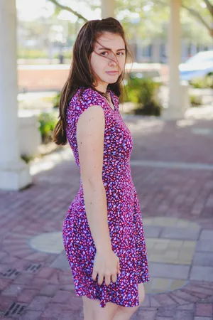 Graceful Woman In Enchanting Purple Dress Wallpaper