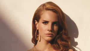 Grammy-nominated Singer Lana Del Rey, Looking Radiant In A Black Ensemble Wallpaper