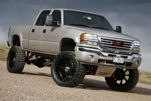 Gray Jacked Up Trucks In The Desert Wallpaper