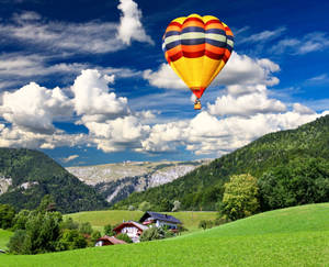 Green Hill And Hot Air Balloon Wallpaper