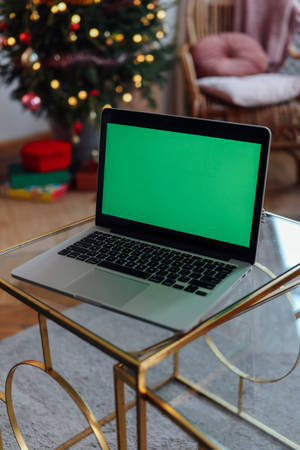 Green Screen Laptop On A Table Wallpaper