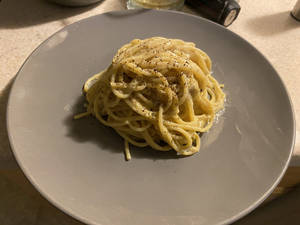 Grey Plate With A Small Serving Of Cacio E Pepe Wallpaper