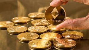 Hand Holding Ethereum Gold Coin Wallpaper