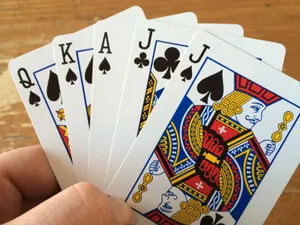 Hand Holding Five Euchre Playing Cards Wallpaper