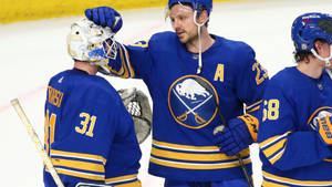 Handsome Canadian Ice Hockey Player Sam Reinhart With Teammates Wallpaper