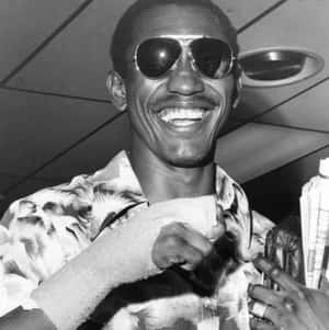 Happy Antonio Cervantes Wearing Sunglasses Wallpaper