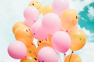 Happy Pink And Yellow Balloons Wallpaper