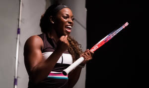 Happy Sloane Stephens Holding A Racket Wallpaper