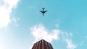 Hd Plane Flying Over Building Wallpaper