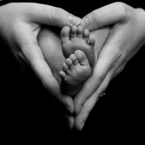 Heart Shaped Hands Cradling Baby Feet Wallpaper