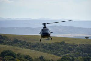 Helicopter Flying Over Landscape Wallpaper