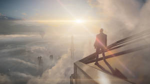 Hitman Full 4k Standing Atop Skyscraper Wallpaper