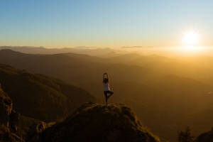 Holistic Yoga On Mountaintop Wallpaper