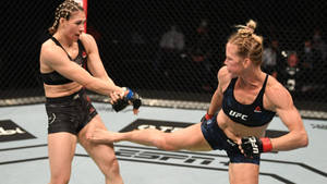 Holly Holm Kicking Irene Aldana Wallpaper