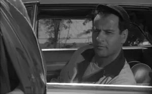Hollywood Legend Eli Wallach Sitting In A Vintage Car. Wallpaper