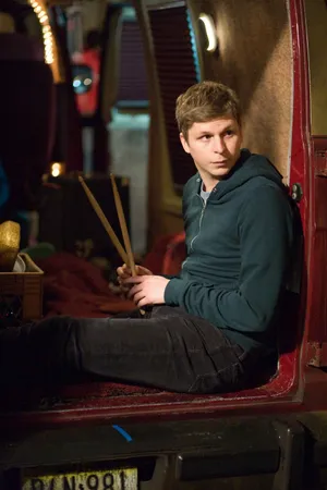 Hollywood Young Actor, Michael Cera Standing With A Slight Smile Wallpaper