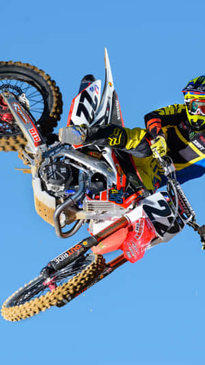 Honda Dirt Bike Posing In Air Wallpaper