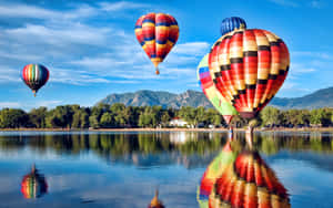 Hot Air Balloons Over Lake Reflection Wallpaper
