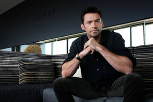 Hugh Jackman On Couch Wallpaper